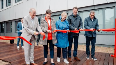 Ein rotes Band vor der Sportschule wird durchschnitten