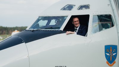 Ministerpräsident Hendrik Wüst schaut aus einem Piloten-Fenster eines NATO-Flugzeugs
