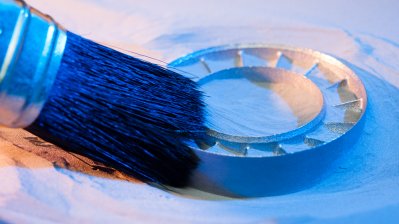 Das fertige runde Bauteil wird mit einem Pinsel gereinigt