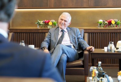 Besprechungssituation in einem festlichen Raum, der Doyen lacht