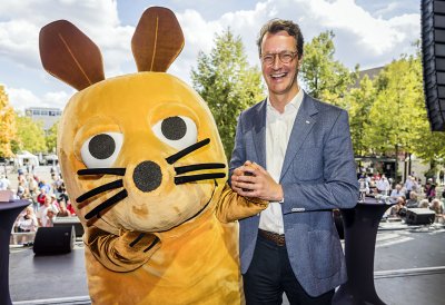 MP Wüst scherzt mit der überlebensgroßen WDR-Maus