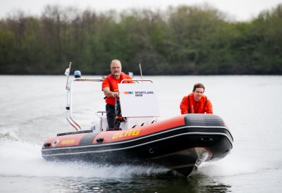 Zwei Männer fahren auf einem Schlauchboot des DLGR über Wasser