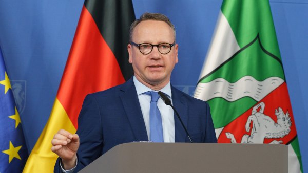 Eine Person spricht am Rednerpult auf einer Pressekonferenz