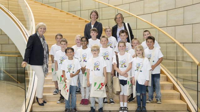 Ministerpräsidentin Hannelore Kraft und Schulklasse stehen auf einer Trepper im Landtag