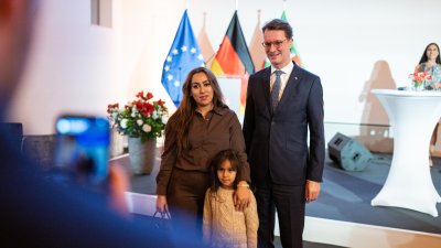 MP Wüst und Neubürger posieren für ein Foto