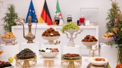 Buffet bei einem Iftar-Empfang, im Hintergund die NRW-Flagge