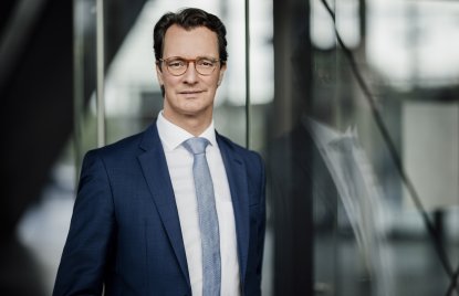 Ministerpräsident Hendrik Wüst lächelt in die Kamera